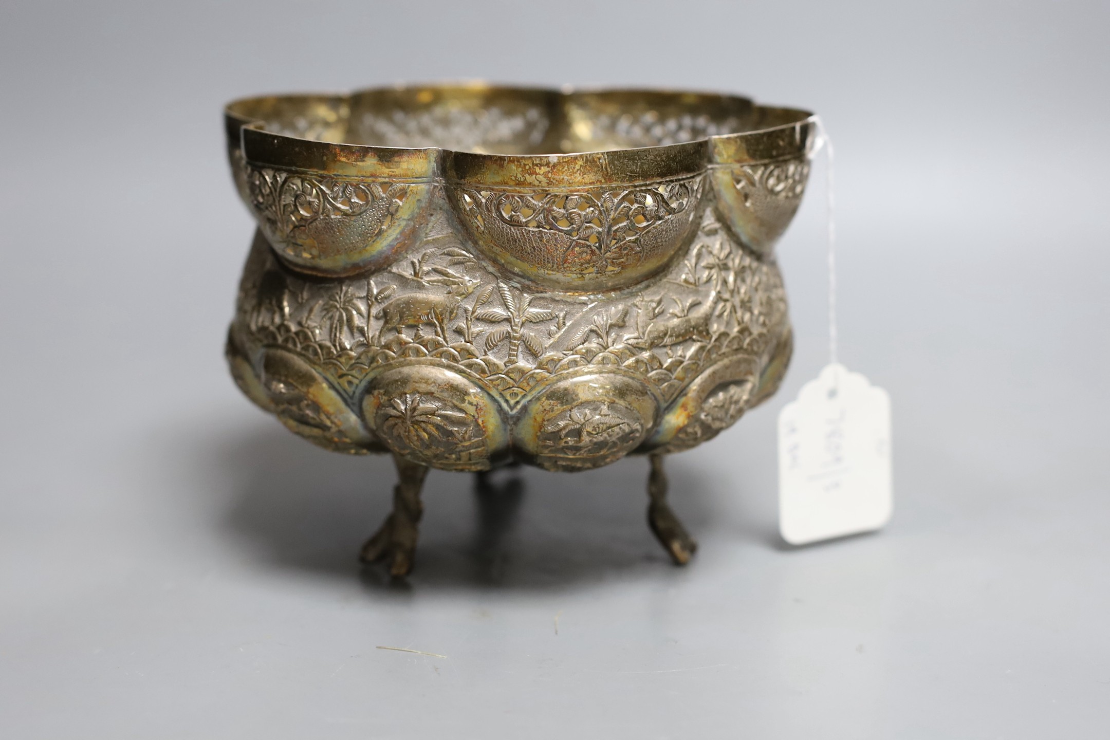 An Indian embossed white metal bowl, on three entwined serpent feet, diameter 17.5cm, 13.9oz.